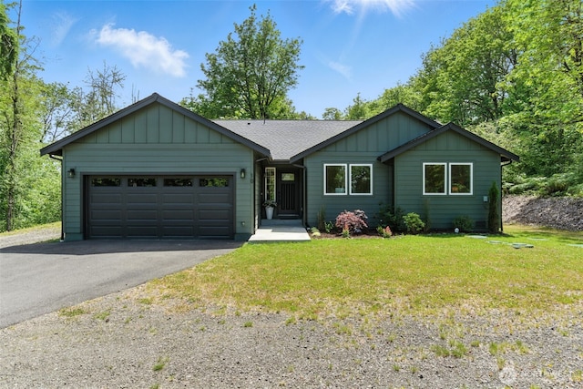 10 Cornwall Rd SW, Lakebay, WA 98349 - single story home featuring asphalt driveway, an attached garage, a front lawn, board and batten siding, and a shingled roof