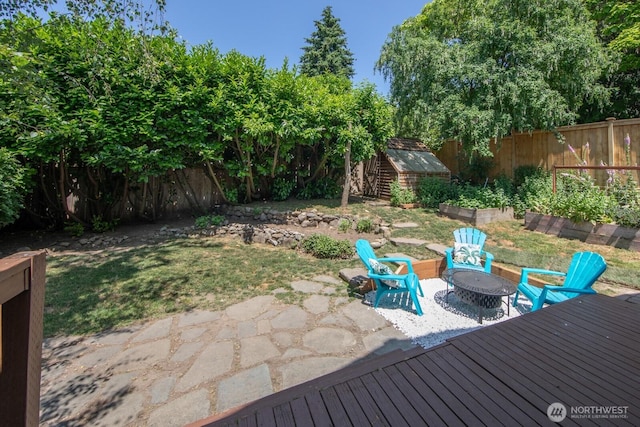 2110 N 88th St, Seattle, WA 98103 - fenced backyard featuring a shed, a patio, and a fire pit