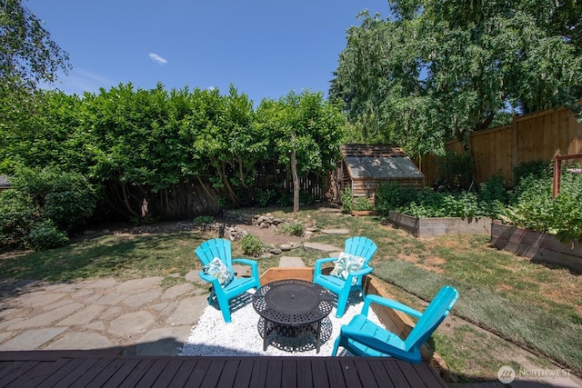 2110 N 88th St, Seattle, WA 98103 - fenced backyard featuring a patio, a shed, and an outdoor fire pit