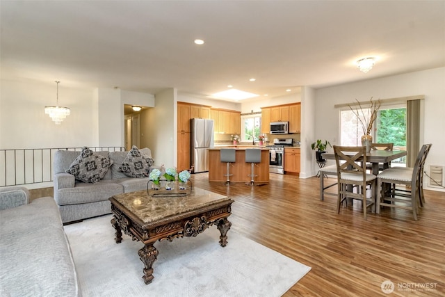 502 SW 326th St, Federal Way, WA 98023 - living room with healthy amount of natural light, wood finished floors, a chandelier, and recessed lighting