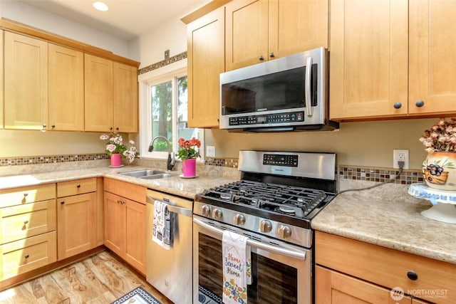 502 SW 326th St, Federal Way, WA 98023 - kitchen with stainless steel appliances, light brown cabinetry, recessed lighting, light stone countertops, and light wood-type flooring