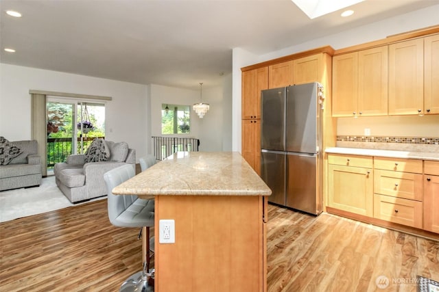 502 SW 326th St, Federal Way, WA 98023 - kitchen with freestanding refrigerator, open floor plan, light wood-style flooring, recessed lighting, and a kitchen island