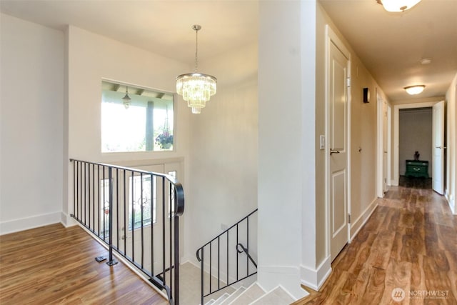 502 SW 326th St, Federal Way, WA 98023 - hall with an upstairs landing, wood finished floors, and a chandelier