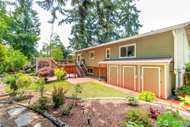 502 SW 326th St, Federal Way, WA 98023 - back of property featuring a garage, stairs, a wooden deck, a yard, and driveway