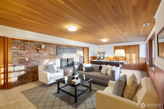 432 SW 206th St, Normandy Park, WA 98166 - living area with brick wall, wooden ceiling, a brick fireplace, a wainscoted wall, and speckle patterned floor