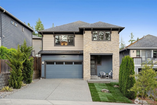 18405 15th Ave W, Lynnwood, WA 98037 - view of front of house with stone siding, driveway, a garage, and a shingled roof