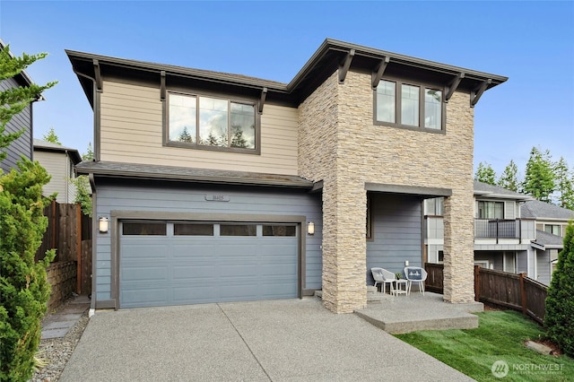 18405 15th Ave W, Lynnwood, WA 98037 - view of front of property featuring an attached garage, concrete driveway, and stone siding