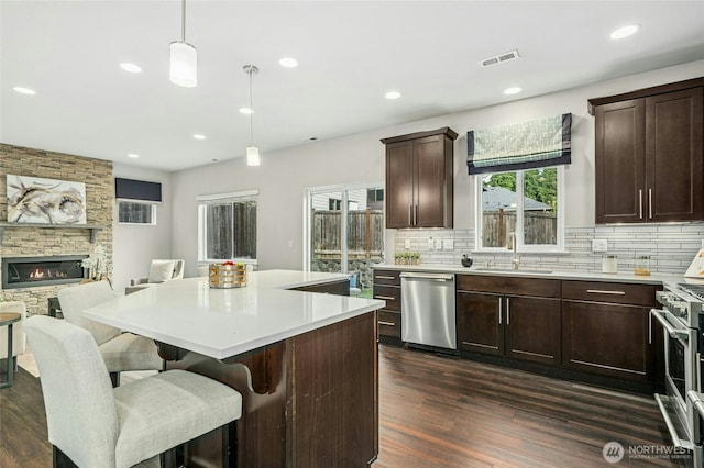 18405 15th Ave W, Lynnwood, WA 98037 - kitchen featuring stainless steel appliances, open floor plan, dark wood-style flooring, decorative backsplash, and recessed lighting