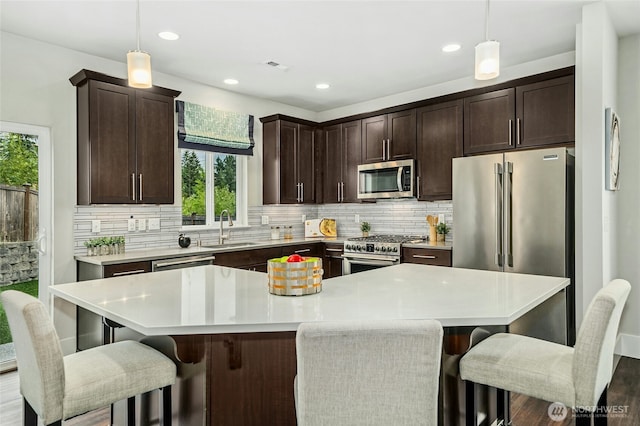 18405 15th Ave W, Lynnwood, WA 98037 - kitchen featuring stainless steel appliances, plenty of natural light, backsplash, dark brown cabinets, and recessed lighting