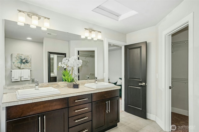 18405 15th Ave W, Lynnwood, WA 98037 - bathroom featuring double vanity, a walk in closet, and tile patterned floors