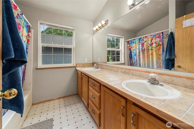 5626 29th Ct SE, Lacey, WA 98503 - bathroom featuring vaulted ceiling, double vanity, tile patterned floors, a shower with shower curtain, and a tub to relax in