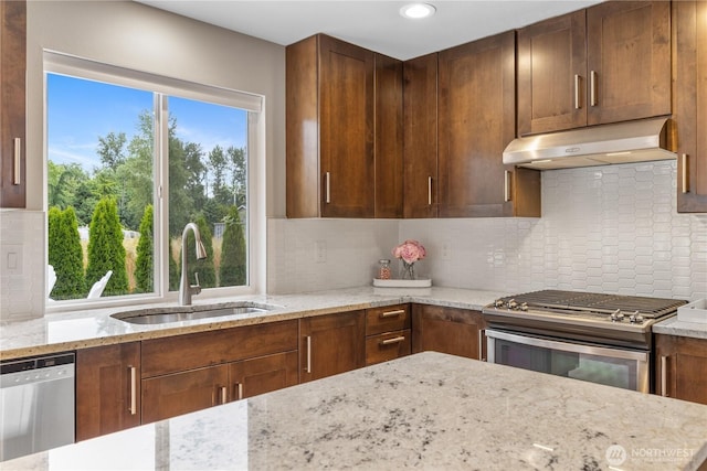 21206 9th Ave SE, Bothell, WA 98021 - kitchen featuring appliances with stainless steel finishes, exhaust hood, light stone countertops, backsplash, and recessed lighting