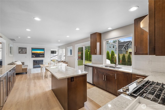 21206 9th Ave SE, Bothell, WA 98021 - kitchen featuring dishwasher, light wood finished floors, open floor plan, backsplash, and a kitchen island