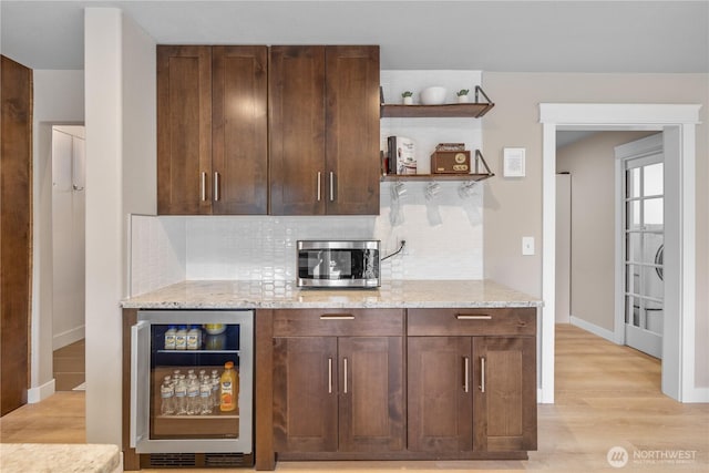 21206 9th Ave SE, Bothell, WA 98021 - kitchen with beverage cooler, decorative backsplash, open shelves, light wood-style flooring, and light stone counters
