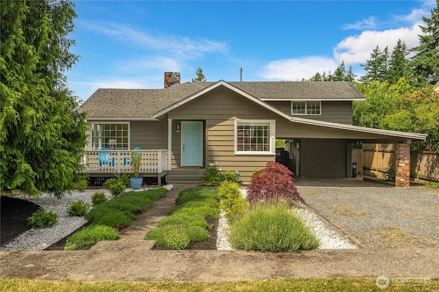 13247 2nd Ave NW, Seattle, WA 98177 - view of front of house with gravel driveway, a chimney, and a carport