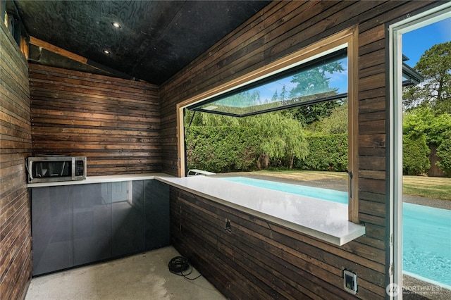 13247 2nd Ave NW, Seattle, WA 98177 - misc room featuring wood walls, vaulted ceiling, and concrete floors