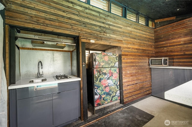 13247 2nd Ave NW, Seattle, WA 98177 - kitchen featuring gray cabinetry, wood walls, appliances with stainless steel finishes, concrete flooring, and light countertops