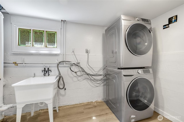 13247 2nd Ave NW, Seattle, WA 98177 - laundry area featuring stacked washer / drying machine and light wood-type flooring
