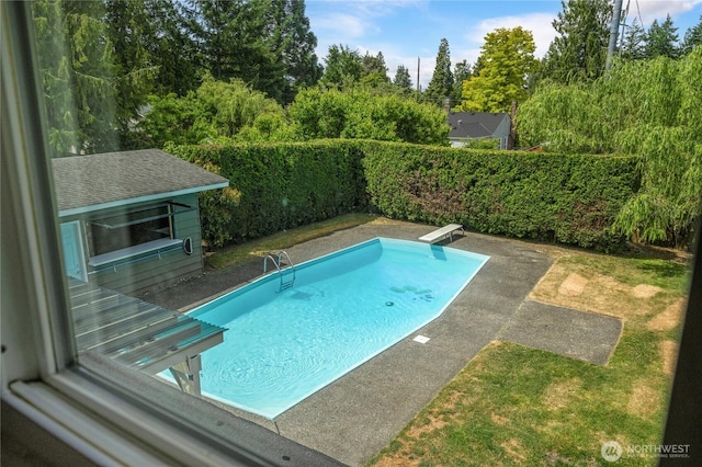 13247 2nd Ave NW, Seattle, WA 98177 - view of swimming pool featuring a diving board, a patio area, a fenced backyard, and view of scattered trees