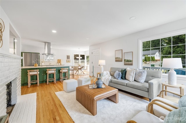 13247 2nd Ave NW, Seattle, WA 98177 - living area with light wood-type flooring, a fireplace, and recessed lighting
