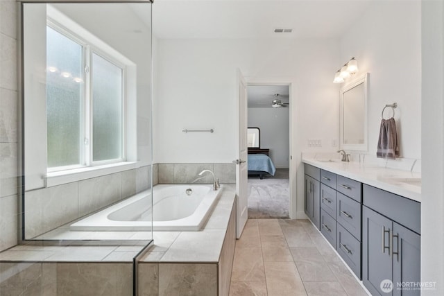 8665 Kimmie Loop SW, Tumwater, WA 98512 - bathroom featuring double vanity, a bath, connected bathroom, ceiling fan, and tile patterned floors