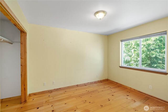 711 S Broadway St, Westport, WA 98595 - unfurnished bedroom with light wood-style flooring and a closet