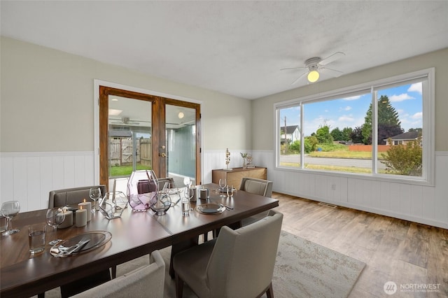 120 E Mason Ave, Buckley, WA 98321 - dining space with wainscoting, ceiling fan, and wood finished floors