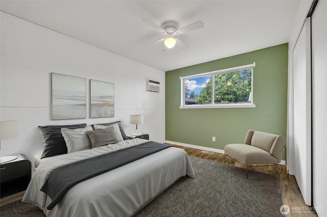 120 E Mason Ave, Buckley, WA 98321 - bedroom featuring wood finished floors, a wall mounted air conditioner, and a ceiling fan