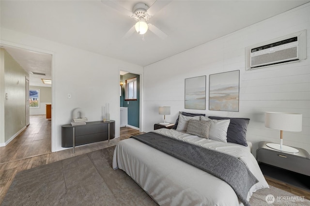 120 E Mason Ave, Buckley, WA 98321 - bedroom featuring wood finished floors, an AC wall unit, ceiling fan, and ensuite bath