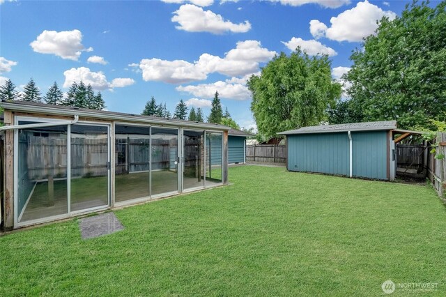 120 E Mason Ave, Buckley, WA 98321 - fenced backyard featuring a sunroom and an outbuilding