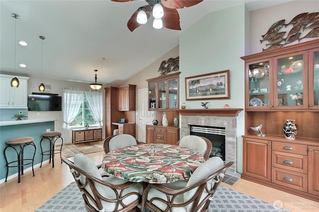 2237 Mcdonald Ave, Dupont, WA 98327 - dining room with a ceiling fan, a fireplace, lofted ceiling, light wood-style floors, and recessed lighting