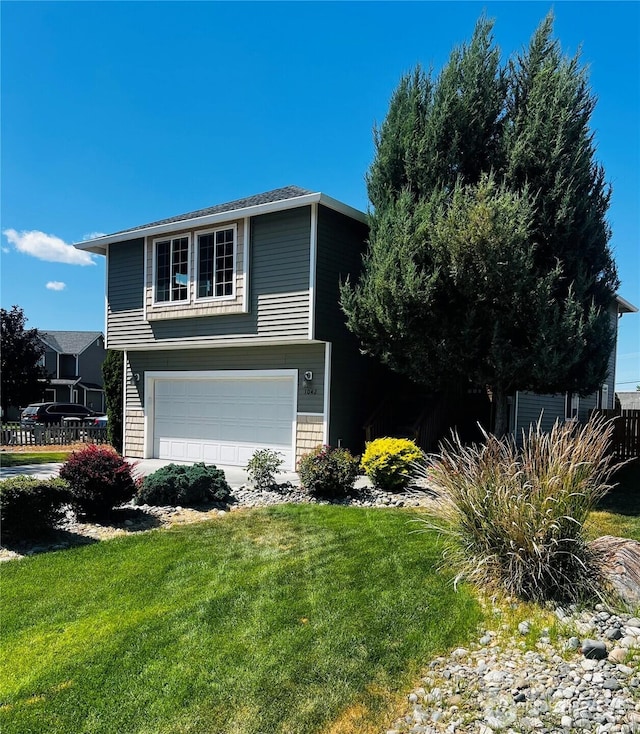 1042 S Lakeland Dr, Moses Lake, WA 98837 - view of home's exterior featuring a yard and a garage