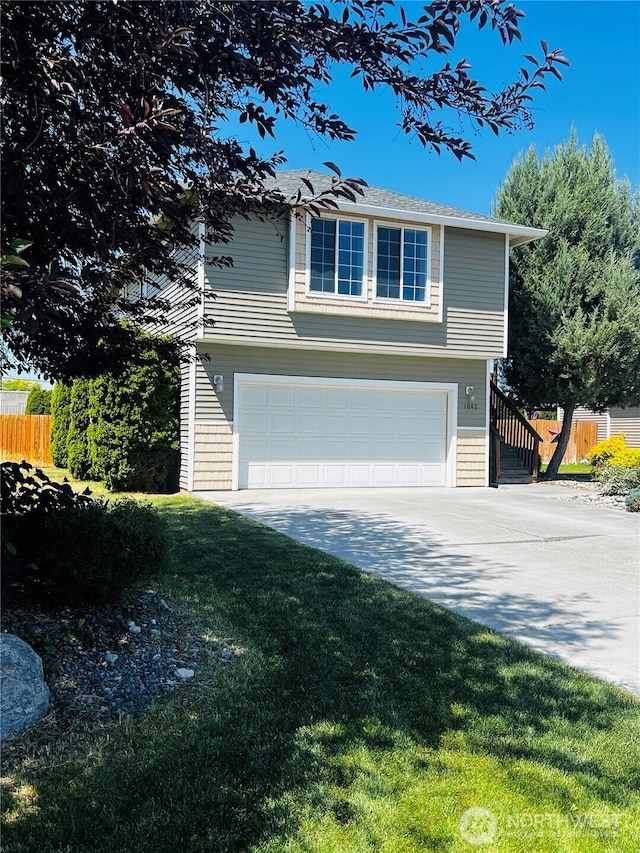1042 S Lakeland Dr, Moses Lake, WA 98837 - view of front of house featuring an attached garage and concrete driveway