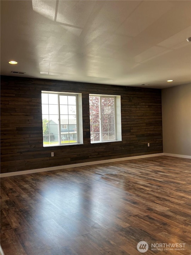 1042 S Lakeland Dr, Moses Lake, WA 98837 - spare room featuring dark wood-style floors, healthy amount of natural light, wood walls, and recessed lighting