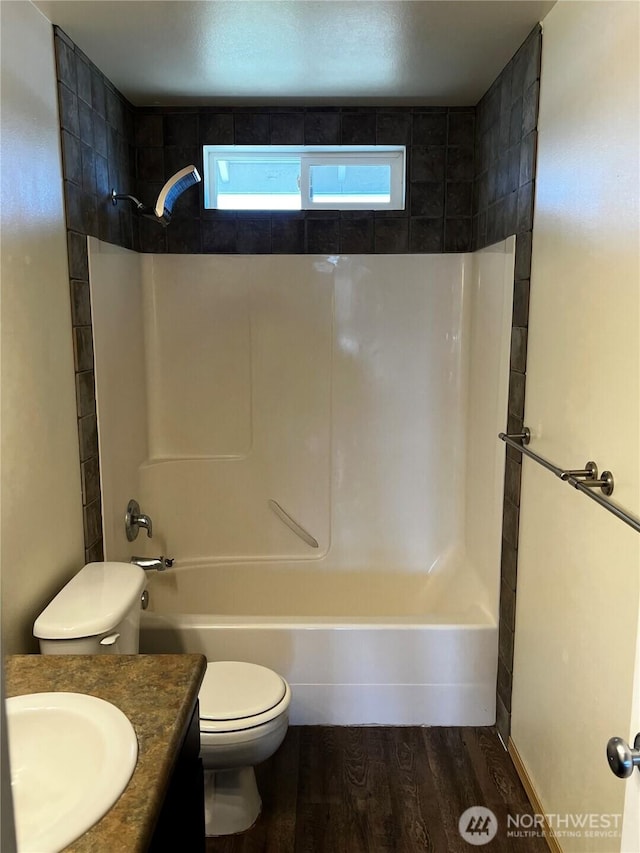 1042 S Lakeland Dr, Moses Lake, WA 98837 - bathroom featuring wood finished floors, vanity, and bathtub / shower combination