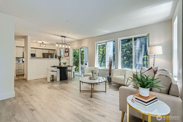 5589 Lakemont Blvd SE Unit 1703, Bellevue, WA 98006 - living area featuring light wood-style floors and a chandelier