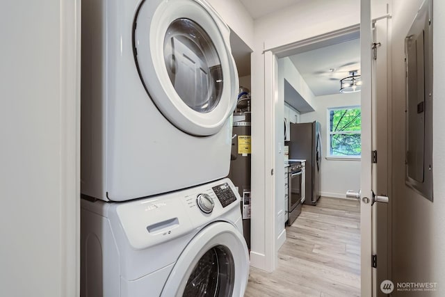 5589 Lakemont Blvd SE Unit 1703, Bellevue, WA 98006 - washroom with estacked washer and dryer and light wood finished floors
