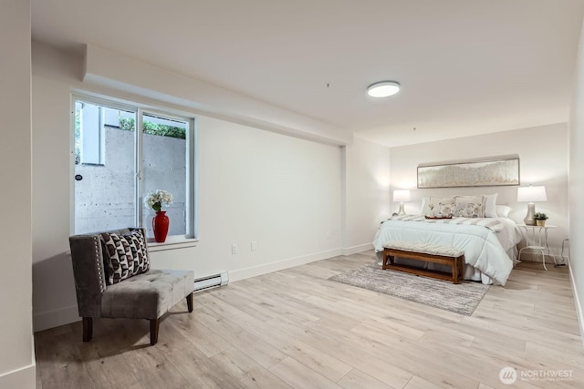 5589 Lakemont Blvd SE Unit 1703, Bellevue, WA 98006 - bedroom with a baseboard radiator and wood finished floors