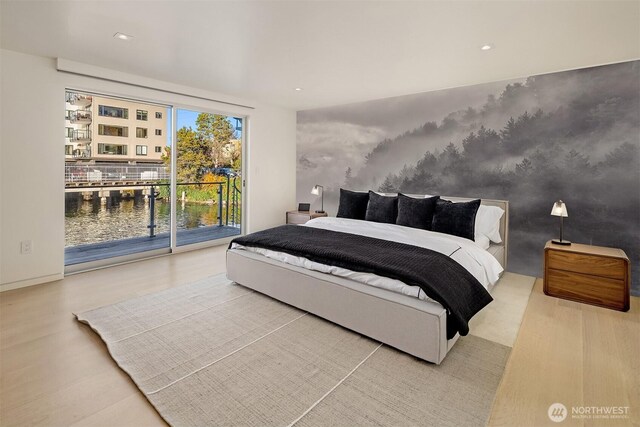 2241 Fairview Ave E Unit B, Seattle, WA 98102 - bedroom featuring access to exterior, a water view, and wood finished floors