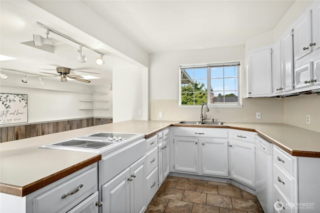 1037 Harding St, Enumclaw, WA 98022 - kitchen with a peninsula, white appliances, white cabinets, a ceiling fan, and dark stone finish floors