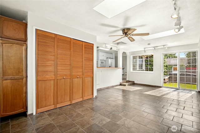 1037 Harding St, Enumclaw, WA 98022 - unfurnished sunroom featuring a skylight, rail lighting, and arched walkways