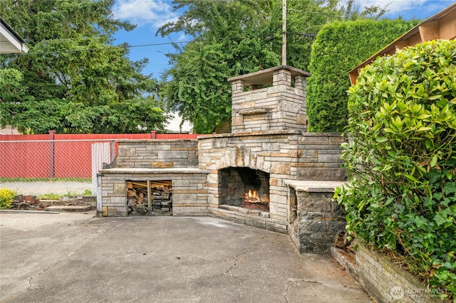 1037 Harding St, Enumclaw, WA 98022 - view of patio featuring an outdoor stone fireplace