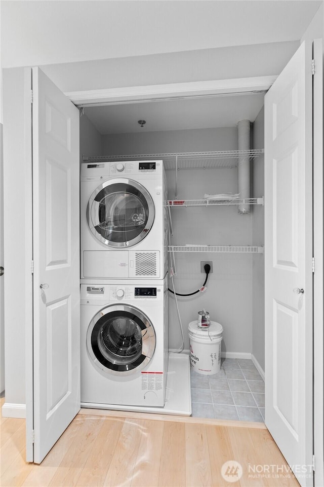 177 NE 107th Ave Unit 1601, Bellevue, WA 98004 - washroom with estacked washer and dryer and wood finished floors