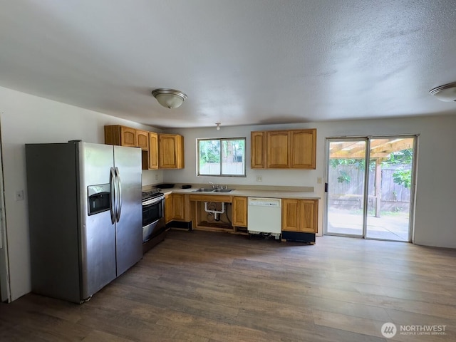 6420 NE Nelson St, Suquamish, WA 98392 - kitchen featuring fridge with ice dispenser, stainless steel electric range, white dishwasher, dark wood-style flooring, and light countertops