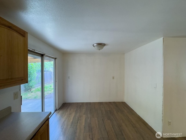 6420 NE Nelson St, Suquamish, WA 98392 - unfurnished dining area featuring wood finished floors