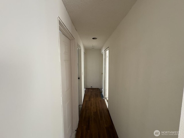 6420 NE Nelson St, Suquamish, WA 98392 - corridor featuring dark wood-type flooring and a textured ceiling