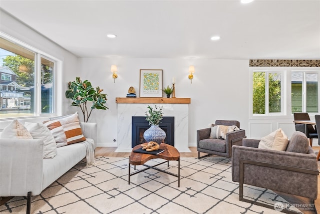 7006 20th Ave NE, Seattle, WA 98115 - living room featuring healthy amount of natural light, recessed lighting, light wood-style flooring, and a high end fireplace