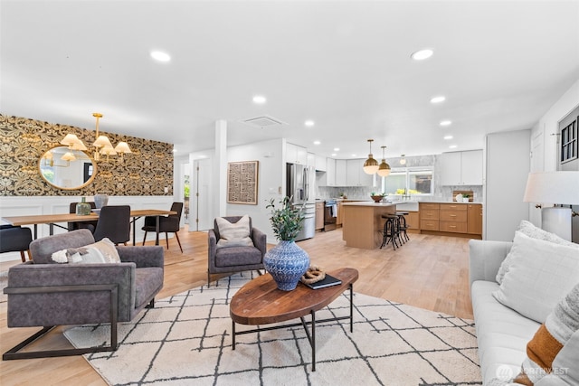 7006 20th Ave NE, Seattle, WA 98115 - living area featuring light wood-type flooring, recessed lighting, a chandelier, plenty of natural light, and wallpapered walls