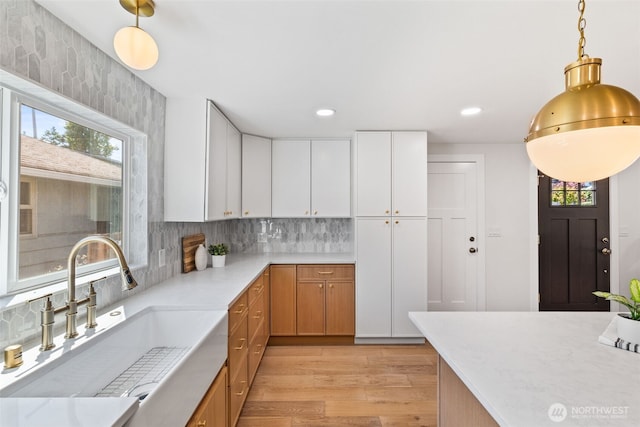 7006 20th Ave NE, Seattle, WA 98115 - kitchen with healthy amount of natural light, light countertops, light wood-style flooring, and recessed lighting