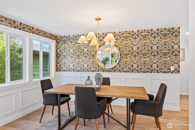 7006 20th Ave NE, Seattle, WA 98115 - dining space featuring wallpapered walls, a chandelier, a decorative wall, a wainscoted wall, and light wood-style flooring